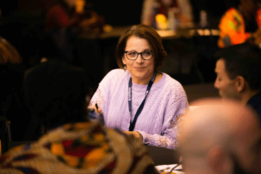 Woman with lanyard holding a meeting